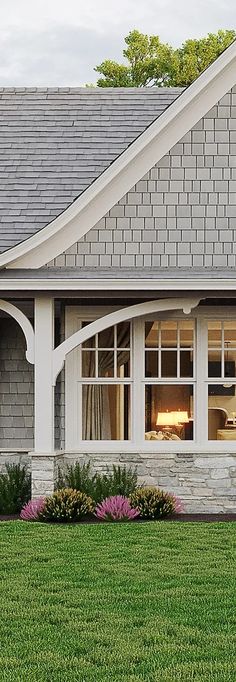 a house with a clock in the front yard