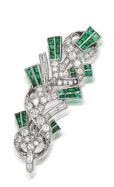 A diamond and emerald brooch, Tiffany & Co.  of foliate motif, detailed with calibré-cut emeralds and baguette-cut diamonds, further accentuated by a ribbon of round brilliant-cut diamonds; signed Tiffany & Co; estimated total diamond weight: 2.50 carats; mounted in platinum; length: 2 1/4in. Emerald Brooch, Bijoux Art Deco, Tiffany Jewelry, Tiffany And Co, I Love Jewelry, Vintage Jewels, Fantasy Jewelry, Precious Gems