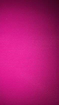 a close up view of a bright pink background