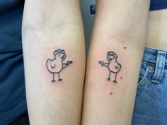 two small tattoos on the arms of people with birds in their beaks, one is pointing at another