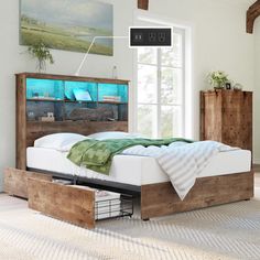 a bed sitting in a bedroom next to a dresser with drawers on each side and a painting hanging above it