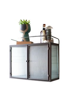 a potted plant sitting on top of a metal cabinet