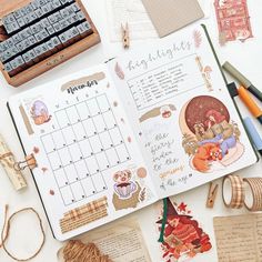 an open planner book sitting on top of a table next to some crafting supplies