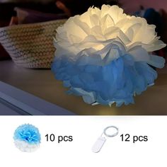 a blue and white paper flower sitting on top of a table next to a basket