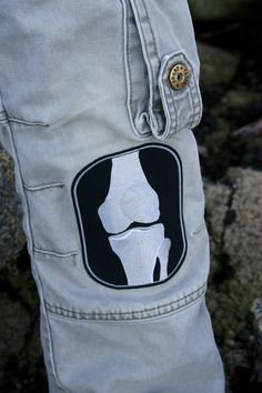 there is a patch on the side of someone's pants that has a bone in it