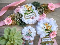 there are flowers and ribbons on the table with name tags attached to each flower head