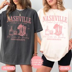 two women wearing nashville t - shirts and shorts with the same shirt on them, one in