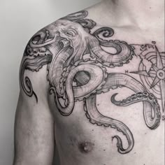 a man with an octopus tattoo on his chest is shown in black and grey ink