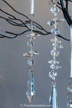 three crystal chandeliers hanging from a tree branch