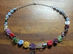 A necklace made out of colorful recycled buttons chained with silver tone jump rings. Recycled Buttons, Button Tree, Button Necklace, Vert Olive, Button Jewelry, Pittsburgh Pa, Beaded Necklaces, Jump Rings, Pittsburgh