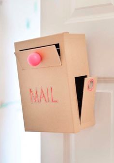 an open mailbox with a pink push button on it