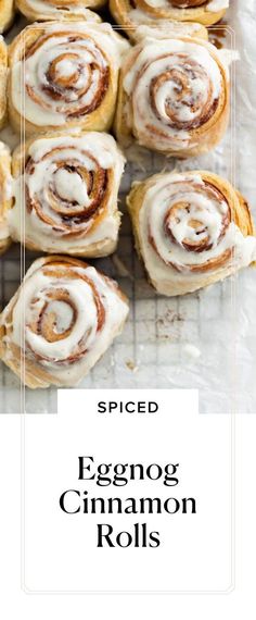 cinnamon rolls on a cooling rack with the title spiced eggnog cinnamon rolls