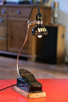 a desk lamp sitting on top of a red table