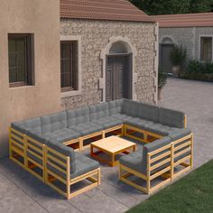 a couch and coffee table sitting on top of a patio next to a stone building