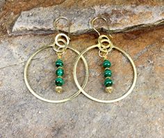 "A beautiful set of large statement gold plated earring hoops with beaded malachite drops. These wonderful fashion statement earrings are a perfect gift for any occasion for the woman in your life. They can be worn with many different styles of clothing and are perfect for both daytime and evening wear. COUPON CODES: Save 10% on purchases totaling $100 or more- enter coupon code 'SAVE10PERCENT' at checkout! Save 15% on purchases totaling $200 or more- enter coupon code 'SAVE15PERCENT' at  checkout! Follow my jewelry on Facebook at \"African Echoes Beads\" Follow my abstract mixed media paintings on Instagram @rodwimerfineart or... www.RodWimerFineArt.com" Gold Bohemian Jewelry With Malachite, Gold Bohemian Malachite Jewelry, Beaded Gold-plated Earrings For Gifts, Brass Beaded Hoop Earrings As Gift, Beaded Brass Hoop Earrings For Gift, Gold-plated Beaded Earrings For Gifts, Gold Plated Beaded Earrings For Gifts, Beaded Malachite Jewelry Gift, Gift Gold-plated Beaded Earrings