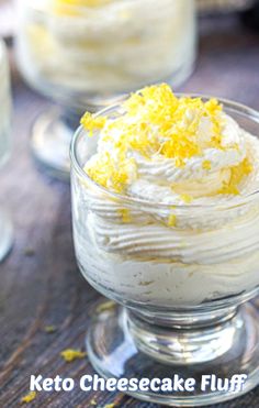 there is a small dessert in a glass bowl on the table with lemons around it