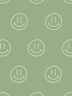 a green background with white smiley faces