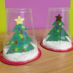 two plastic cups with christmas trees in them