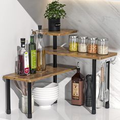 three wooden shelves with spices and condiments on them in a white room next to a marble wall