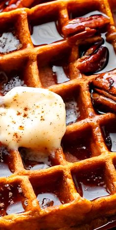 a waffle topped with butter and pecans