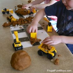 two children playing with construction toys on the table