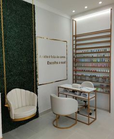 a white chair sitting in front of a table next to a shelf filled with bottles