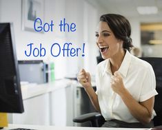 a woman sitting in a chair laughing and holding her fist up to the side with both hands