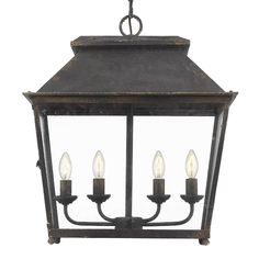 an old fashioned hanging light fixture with four lights on each side and three candles in the middle