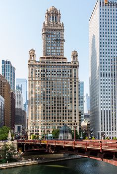 there are many tall buildings in the city and one has a red bridge over it