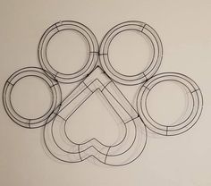 an abstract drawing of circles and shapes on a white surface with black lines in the middle