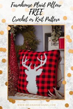 a red and black plaid pillow with a deer head on it in front of a christmas tree