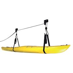 a yellow kayak is hanging from a rope