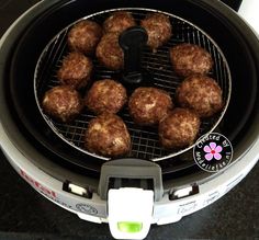 some meatballs are cooking in an air fryer