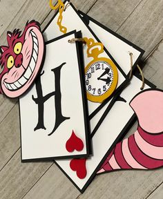 three cards with the letter h on them and a clock hanging from each one's side