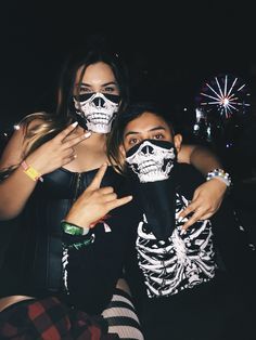 two people with skeleton face paint posing for a photo