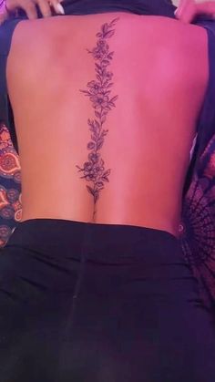 the back of a woman's lower body with flowers on her left and right side