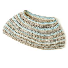 a knitted hat is shown on a white surface with blue and gray stripes in the middle