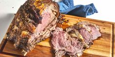 a large piece of meat sitting on top of a wooden cutting board