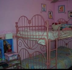 a pink bedroom with two bunk beds and pictures on the wall above them that say i am rotting