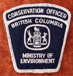 a patch that says conservation officer british columbia on it's front and back side