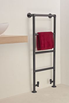 a towel rack with two red towels hanging on it