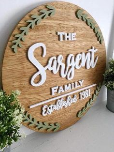 a wooden sign that says the sargetnt family and established 1897 on it next to some potted plants