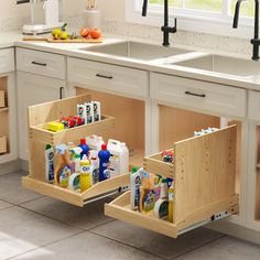 two kitchen cabinets with pull out drawers in the middle