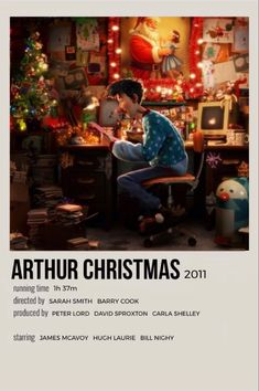 the poster for artur christmas 2011 shows a boy sitting at his desk in front of a computer