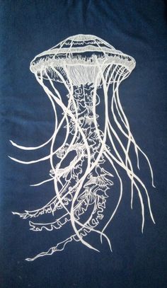 a drawing of a jellyfish in white ink on a dark blue t - shirt