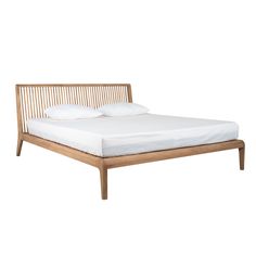 a wooden bed frame with white sheets and pillows on top of it, against a white background