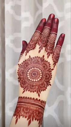 a woman's hand with henna on it