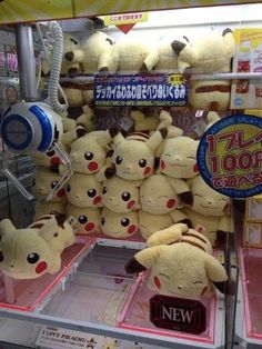 many stuffed animals are on display in a store