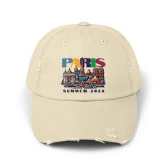 Celebrating Paris this summer? Elevate your look with our 100% cotton twill baseball cap, artfully distressed for that effortlessly cool vibe. The hat features a colorful illustration of the Paris skyline in summer. Perfect for both men and women, this cap is a stylish addition to any wardrobe. Whether you're wandering the neighborhood, soaking up sun at the beach, or enjoying a hike in the woods, this cap promises comfort and flair. The low profile along with the d-ring closure on a self-fabric Summer Sports Snapback Baseball Cap, Summer Snapback Baseball Cap For Sports Events, Summer Sports Baseball Cap With Curved Brim, Urban Summer Visor Hat, Urban Style Summer Visor Hat, Urban Style Visor Hats For Summer, Urban Visor Hats For Summer, Curved Brim Baseball Cap For Summer Sports Events, Curved Brim Baseball Cap For Summer Sports