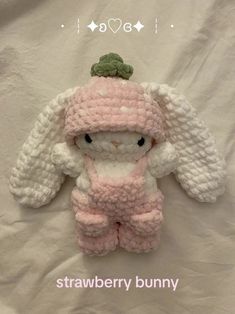 a crocheted stuffed animal wearing a pink outfit